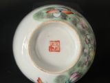 a white bowl with a green and red design on it