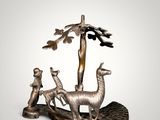 an image of a statue of a man and two llamas in a tree