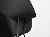 the back of a black chair with a black seat on a white background