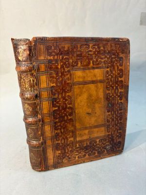un vieux livre à la couverture brune posé sur une table