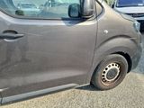 a small gray van parked in a parking lot