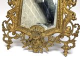 a gold frame with a picture of a man in it