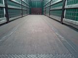 an image of a metal walkway with green glass walls