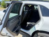 a white car with the door open and the driver ' s seat down