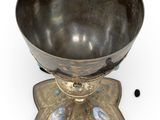 an image of a metal bowl sitting on top of a metal stand
