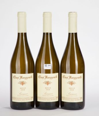 three bottles of wine sitting on top of a white table