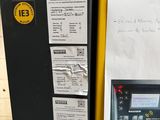 a yellow box with a sign on it next to a black box