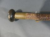 a close up of a knife with a handle on a table