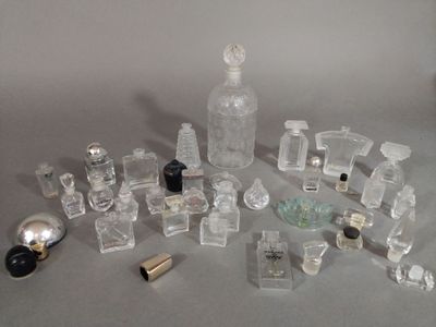 a lot of perfume bottles and a bottle of perfume on a table
