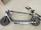 a scooter that is sitting on the floor next to a box