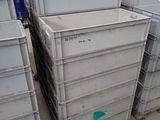 a lot of crates that are stacked up in a warehouse