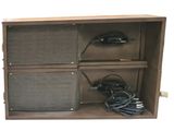 a picture of a cabinet with two speakers and a charger