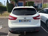 a white car parked in a parking lot next to a white car