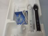 a wii remote in a white box with a charger