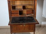 a wooden desk with a marble top in a room