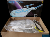 a cardboard box with a model of a star trek ship in it