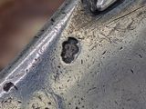 a close up of a metal object with a hole in it