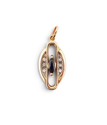 a close up of a gold pendant with a blue stone