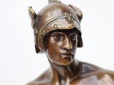 bronze statue of a man with a helmet on his head