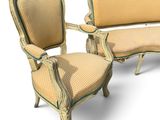 two chairs and a couch that are sitting next to each other