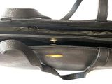 a black purse that is open on a white surface