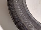 a close up of a tire on a wall with a white background