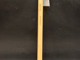 a hammer with a wooden handle sitting on top of a table