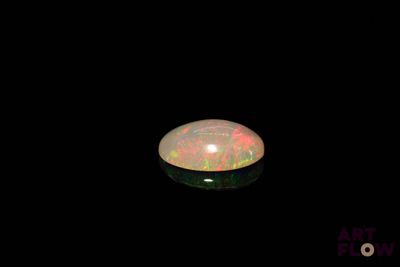 an image of a white fire opal in the dark
