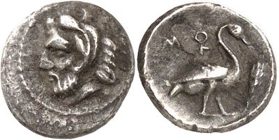 a close up of a coin with a bird on it