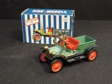 a small toy truck with a box on a table