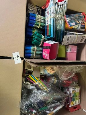 two boxes with pens and pencils in them on a shelf
