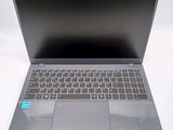 a silver laptop with a blue sticker on the keyboard