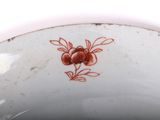 a close up of a bowl with a flower on it