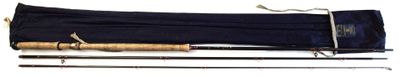 two fishing rods and a bag on a white surface