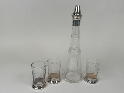 three glasses and a decanter sitting on a table