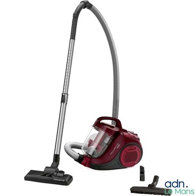un aspirateur rouge est posé par terre à côté d'un autre aspirateur