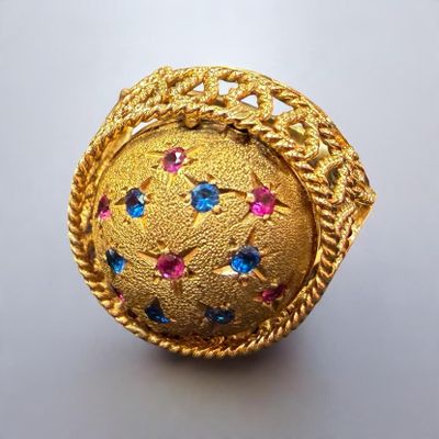 an image of a gold ring with multi colored stones on it
