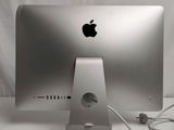 a silver apple computer sitting on top of a white table