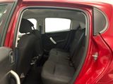 a red car with a black seat in the back of it