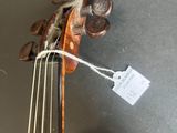 a close up of a violin on a table with a price tag