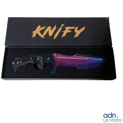 a knife in a black box with a purple handle