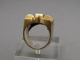 an image of a gold and silver ring on a clear stand