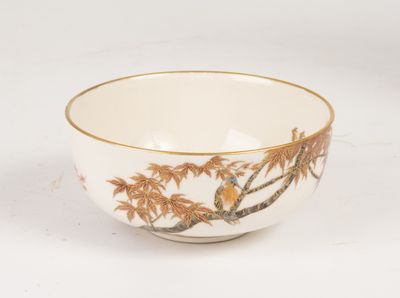 a small bowl with a bird on it on a table