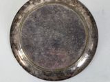 a silver plate on a white table with a white background