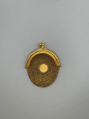 a gold coin purse with a chain around it