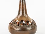 a brown vase with a brown and white design on it