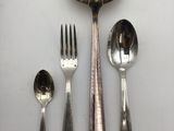 a spoon, fork, and spoon rest on a table