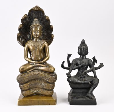 deux statues en bronze représentant une femme et un homme assis sur un rocher