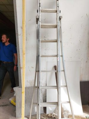 a man that is standing next to a ladder
