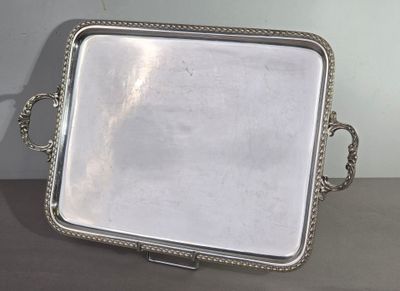 a silver tray with a handle on it on a table